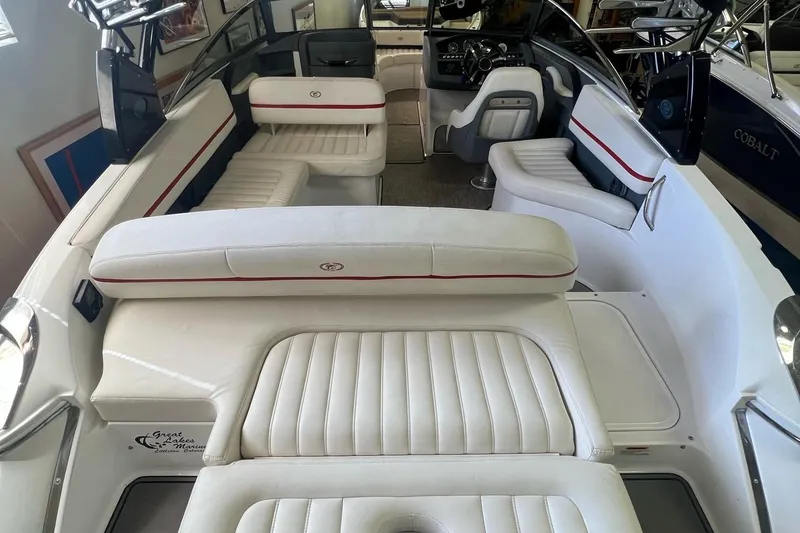 Slide: The Image of 2016 Cobalt R5 WSS boat interior with white leather seating and modern dashboard. - 10