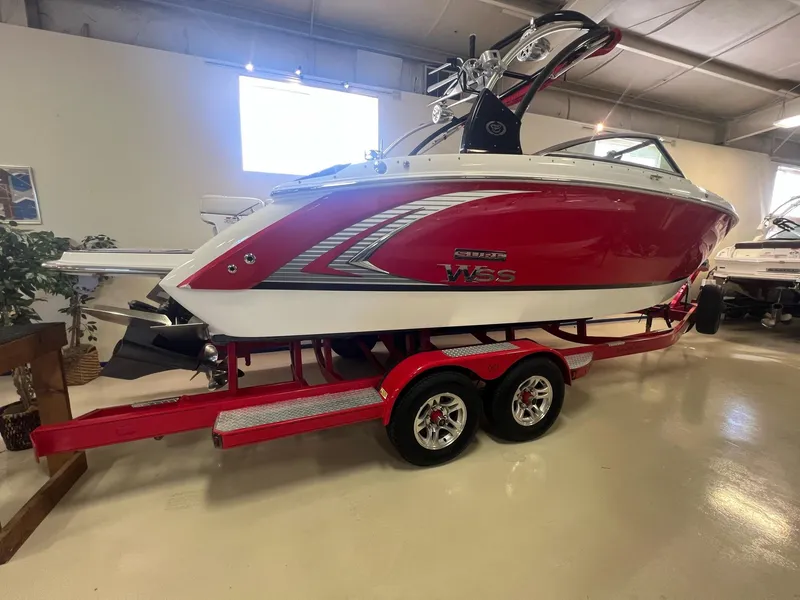 Slide: The Image of 2016 Cobalt R5 WSS red and white boat on a matching trailer in a showroom. - 3