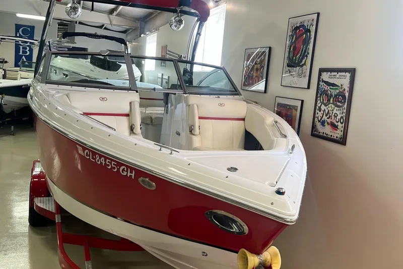 Slide: The Image of 2016 Cobalt R5 WSS boat in showroom, red and white exterior, on trailer. - 6