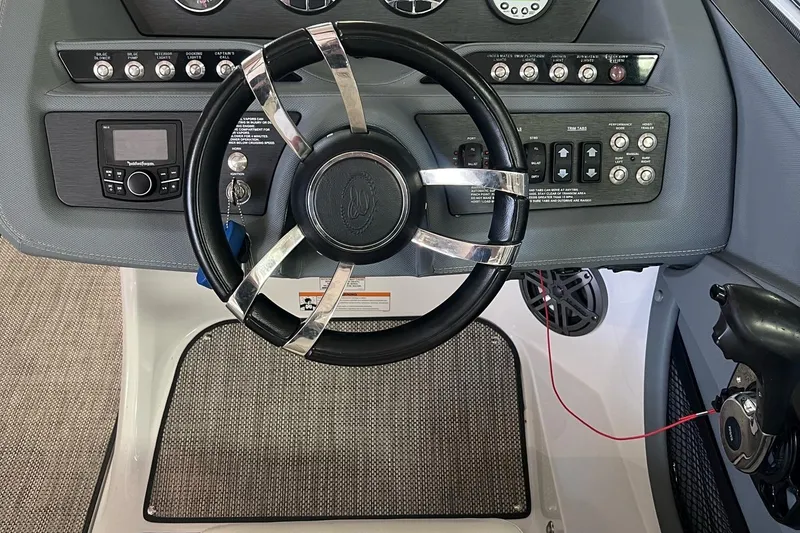 Slide: The Image of 2016 Cobalt R5 WSS boat dashboard with steering wheel and control panel. - 8