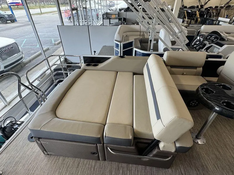 Slide: The Image of 2023 Godfrey SW 2486 SFL pontoon boat interior with beige seating and cup holders. - 10