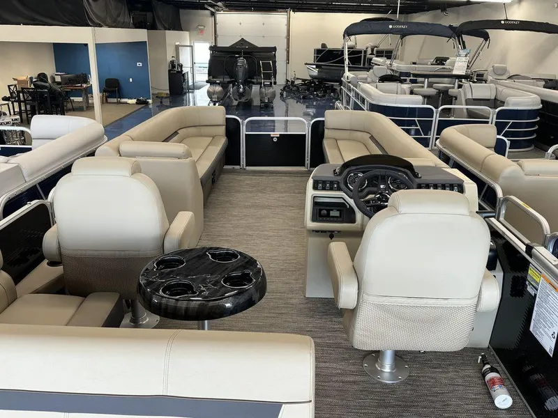 Slide: The Image of Interior of 2023 Godfrey SW 2486 SFL pontoon boat with beige seating and black table. - 12