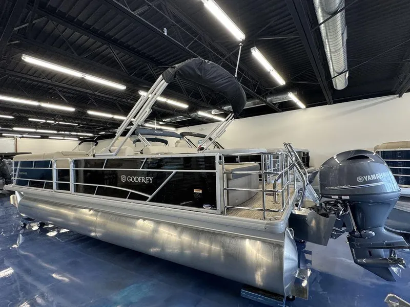 Slide: The Image of 2023 Godfrey SW 2486 SFL pontoon boat in showroom with Yamaha outboard motor. - 4