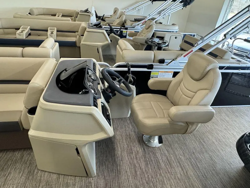 Slide: The Image of 2023 Godfrey SW 2486 SFL boat interior with beige captain's chair and control console. - 7