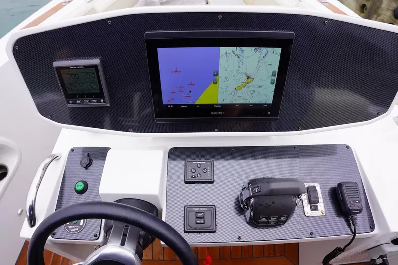 Slide: The Image of Novurania Chase 2020 boat dashboard with navigation screens and controls. - 11