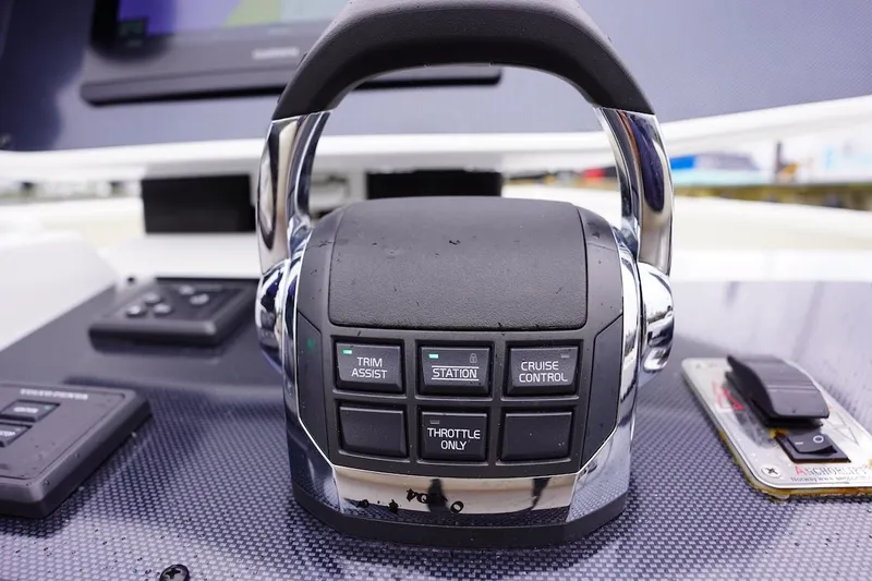 Slide: The Image of Close-up of 2020 Novurania Chase boat throttle control with trim assist and cruise control buttons. - 37