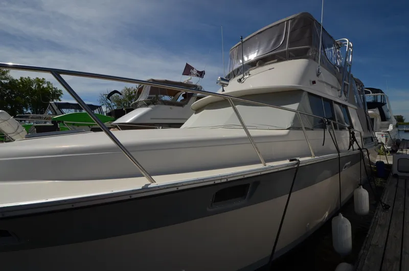 Slide: The Image of 1986 Silverton 40 Aft Cabin yacht docked at marina. - 1