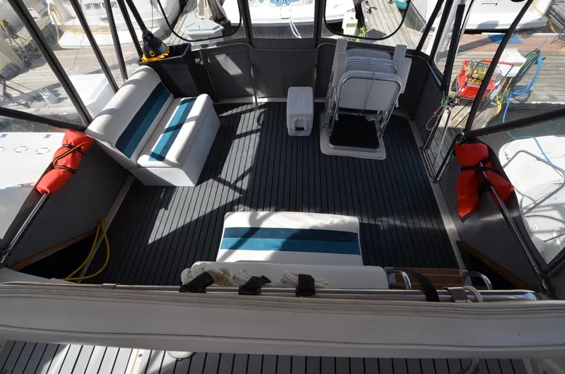 Slide: The Image of 1986 Silverton 40 Aft Cabin boat interior with seating and life jackets. - 10