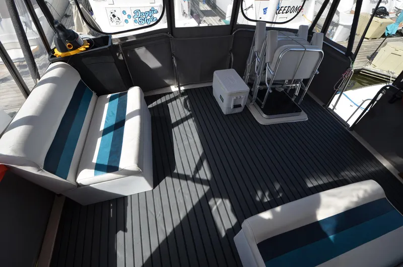 Slide: The Image of 1986 Silverton 40 Aft Cabin boat interior with seating and cooler. - 12