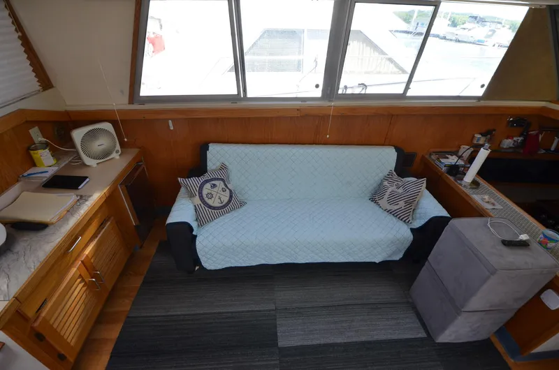 Slide: The Image of Interior of 1986 Silverton 40 Aft Cabin with sofa and nautical decor. - 19