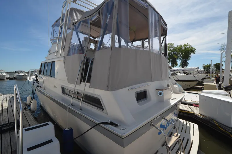 Slide: The Image of 1986 Silverton 40 Aft Cabin yacht docked at marina. - 2