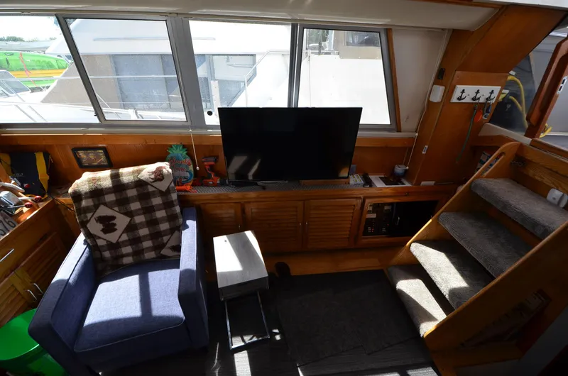 Slide: The Image of Interior of 1986 Silverton 40 Aft Cabin with TV, chair, and stairs. - 20