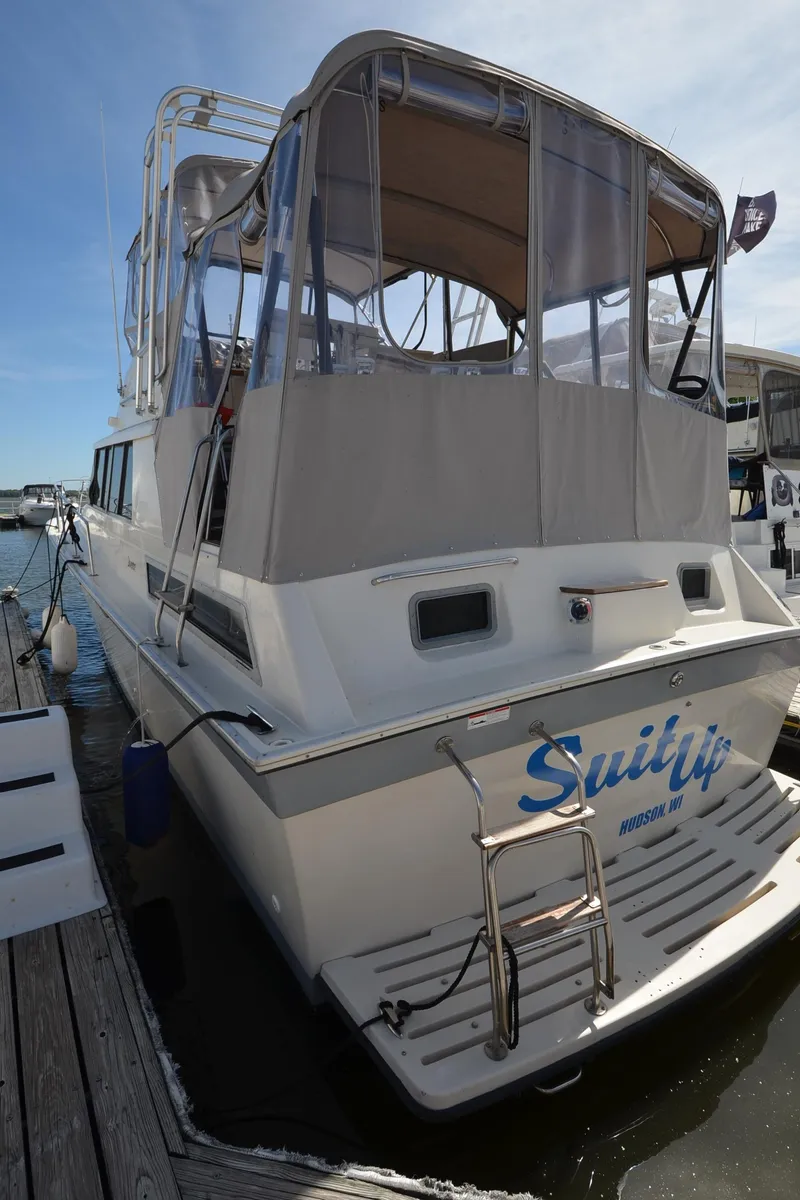 Slide: The Image of 1986 Silverton 40 Aft Cabin yacht docked at a marina. - 28