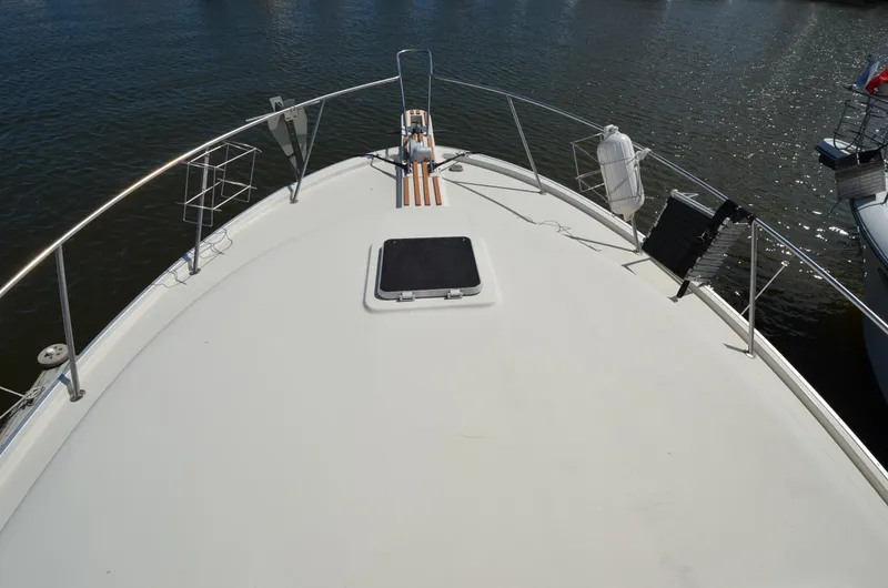 Slide: The Image of 1986 Silverton 40 Aft Cabin yacht bow deck with railing and hatch. - 3