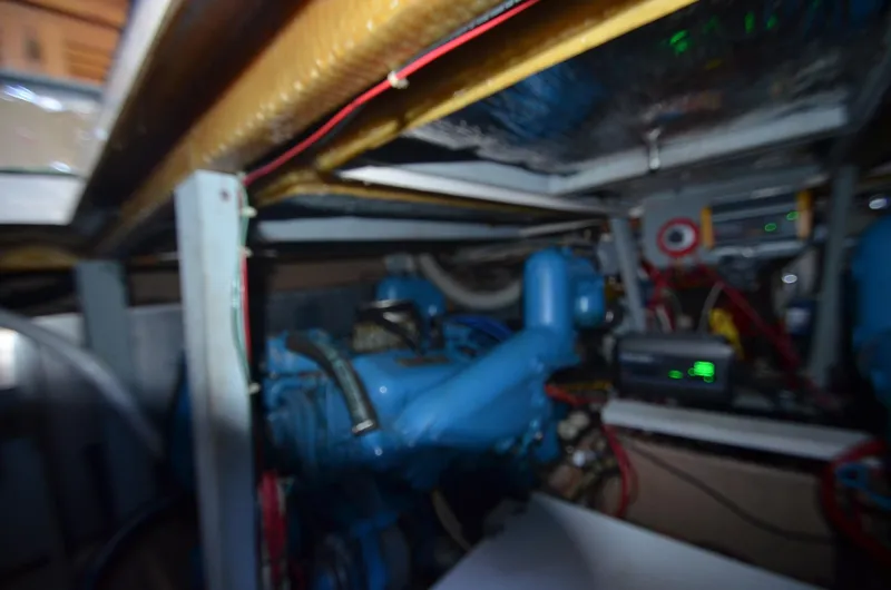 Slide: The Image of Engine room of a 1986 Silverton 40 Aft Cabin boat with visible blue engine. - 32
