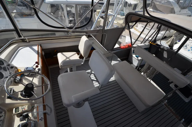 Slide: The Image of 1986 Silverton 40 Aft Cabin boat helm with seating and controls. - 8