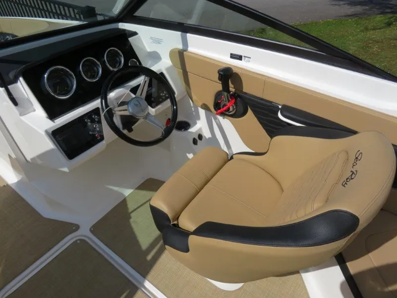 Slide: The Image of 2022 Sea Ray 21 SPX boat interior with tan leather seating and modern dashboard. - 5