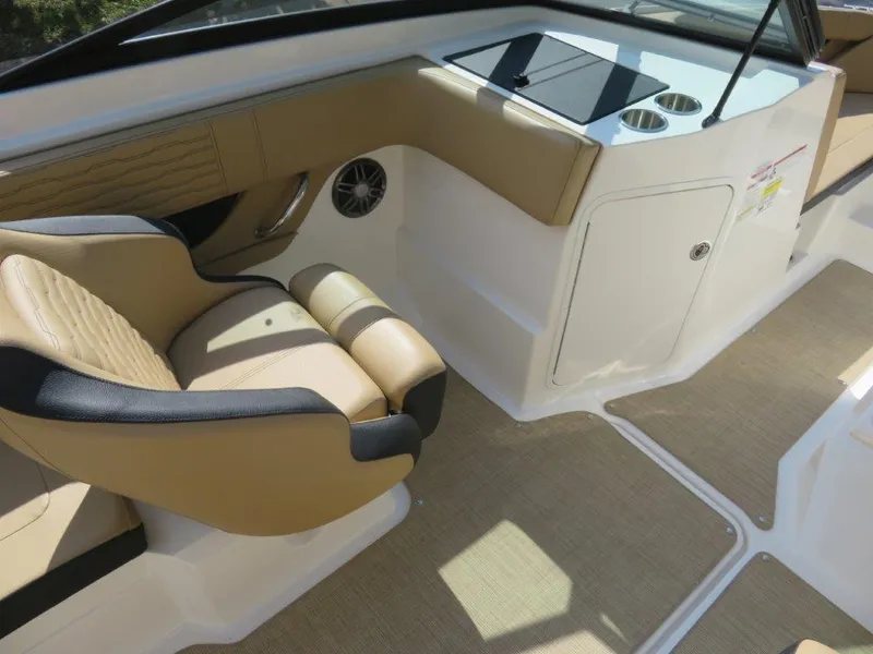 Slide: The Image of 2022 Sea Ray 21 SPX boat interior with tan seating and cup holders. - 6