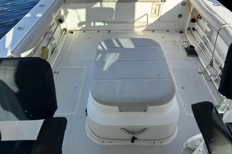 Slide: The Image of 2000 Albin 28 Tournament Express boat interior with cushioned seating and storage. - 10