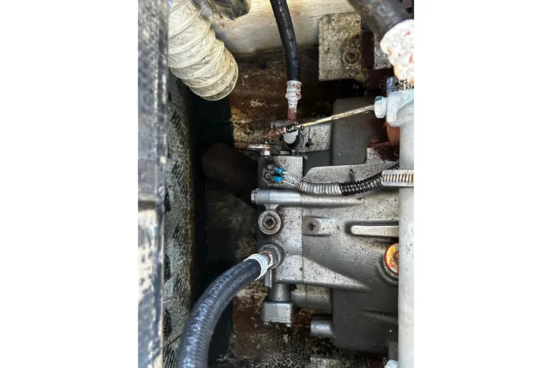 Slide: The Image of Engine compartment of a 2000 Albin 28 Tournament Express boat, showing hoses and components. - 16