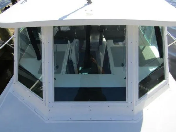 Slide: The Image of 2000 Albin Tournament Express boat cockpit view with large windows. - 5