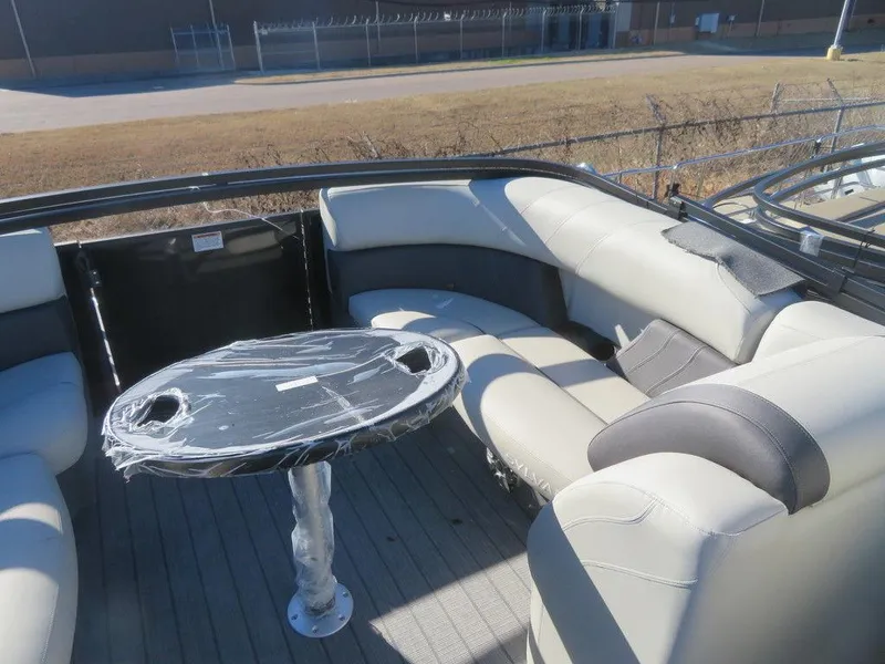 Slide: The Image of 2023 Sylvan Mirage X5 boat with cushioned seating and table. - 15