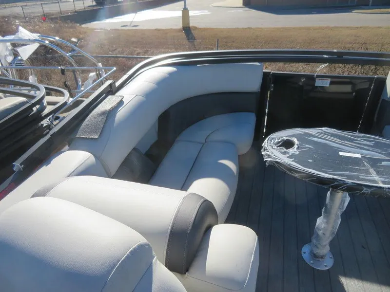 Slide: The Image of 2023 Sylvan Mirage X5 boat interior with cushioned seating and table. - 16