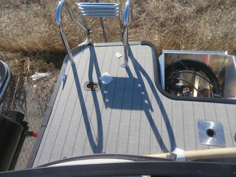 Slide: The Image of 2023 Sylvan Mirage X5 boat deck with ladder and storage compartment. - 18