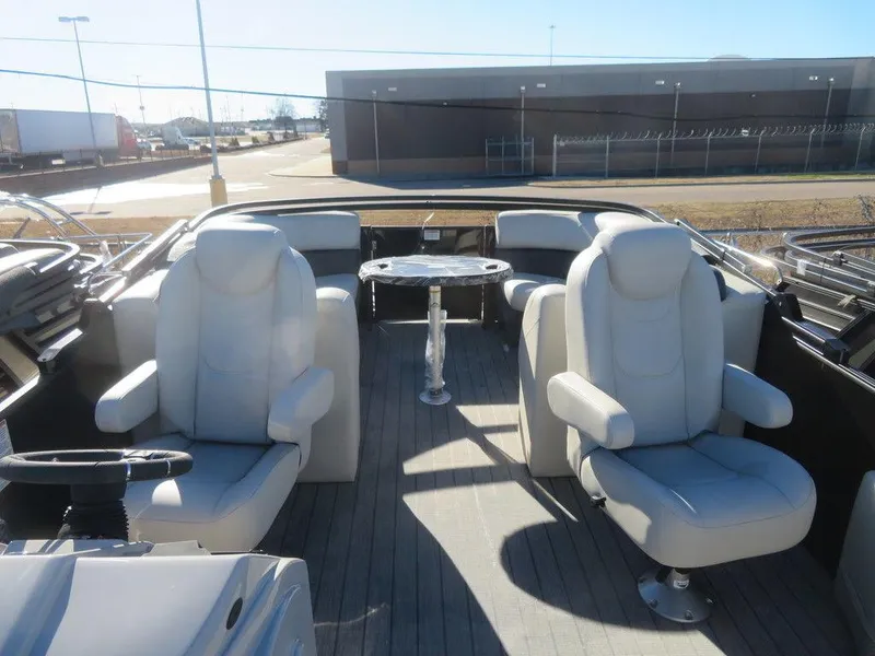 Slide: The Image of 2023 Sylvan Mirage X5 boat interior with plush seating and table. - 7