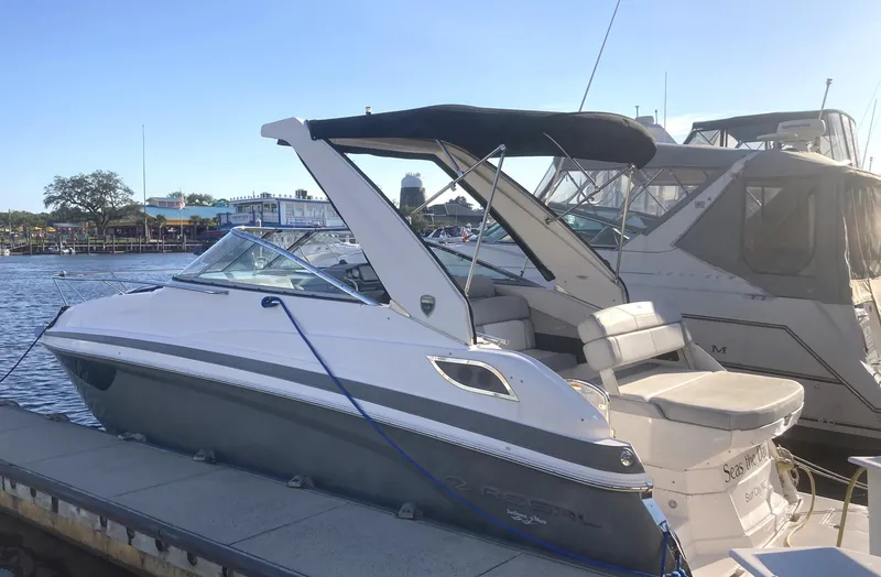 Slide: The Image of 2015 Regal 28 Express boat docked at marina. - 1