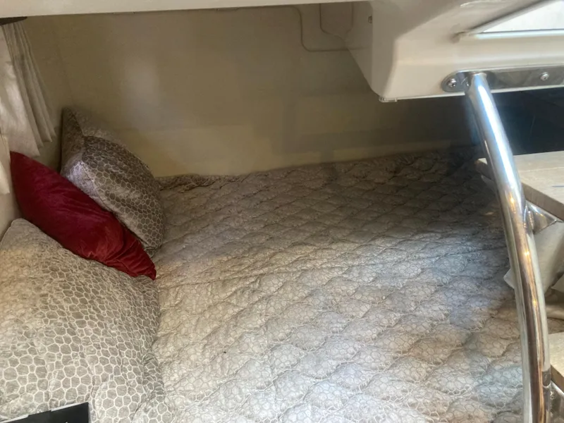 Slide: The Image of Cozy sleeping area in 2015 Regal 28 Express boat with quilted bedding and pillows. - 10