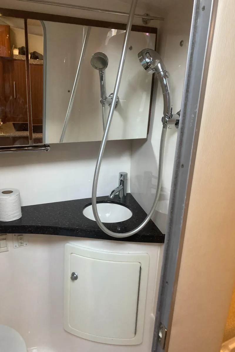 Slide: The Image of 2015 Regal 28 Express bathroom with sink, mirror, and showerhead. - 15