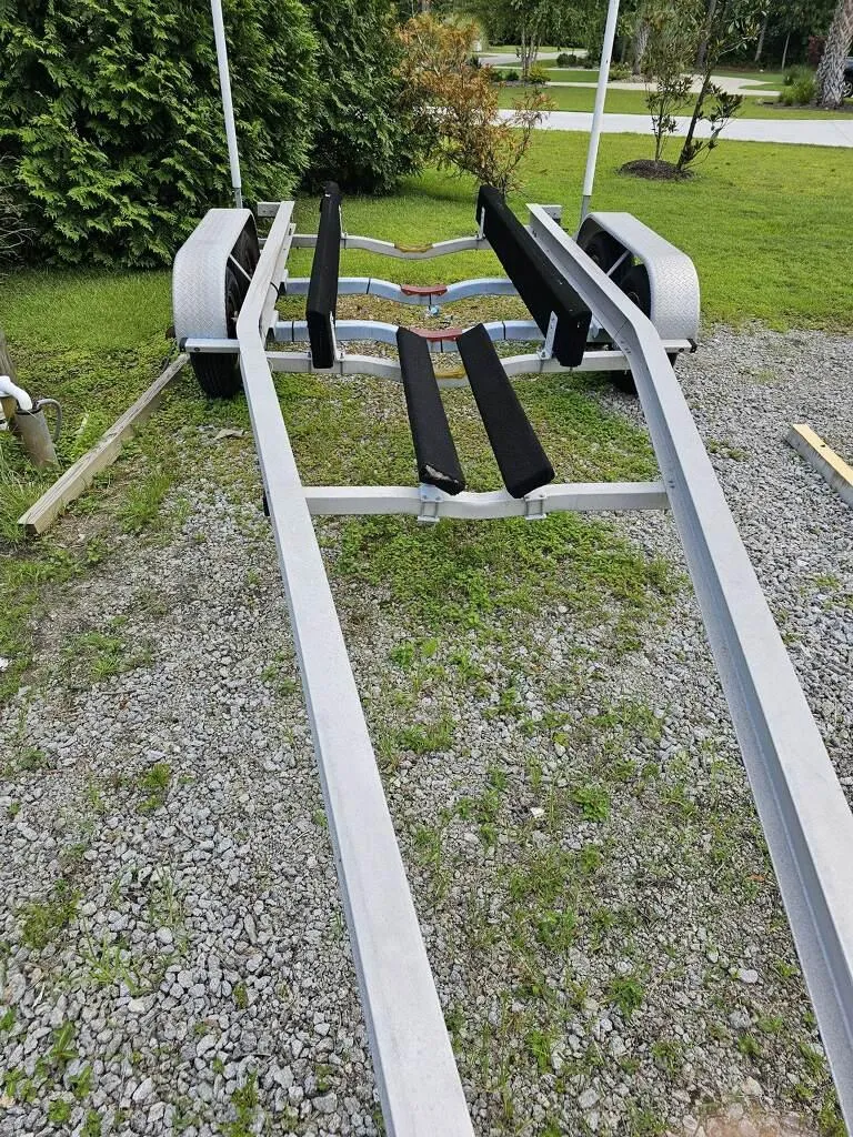Slide: The Image of Boat trailer for 2015 Regal 28 Express on gravel and grass. - 19