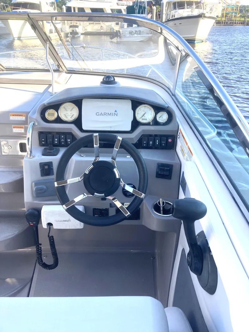 Slide: The Image of 2015 Regal 28 Express boat helm with Garmin navigation system and modern controls. - 4