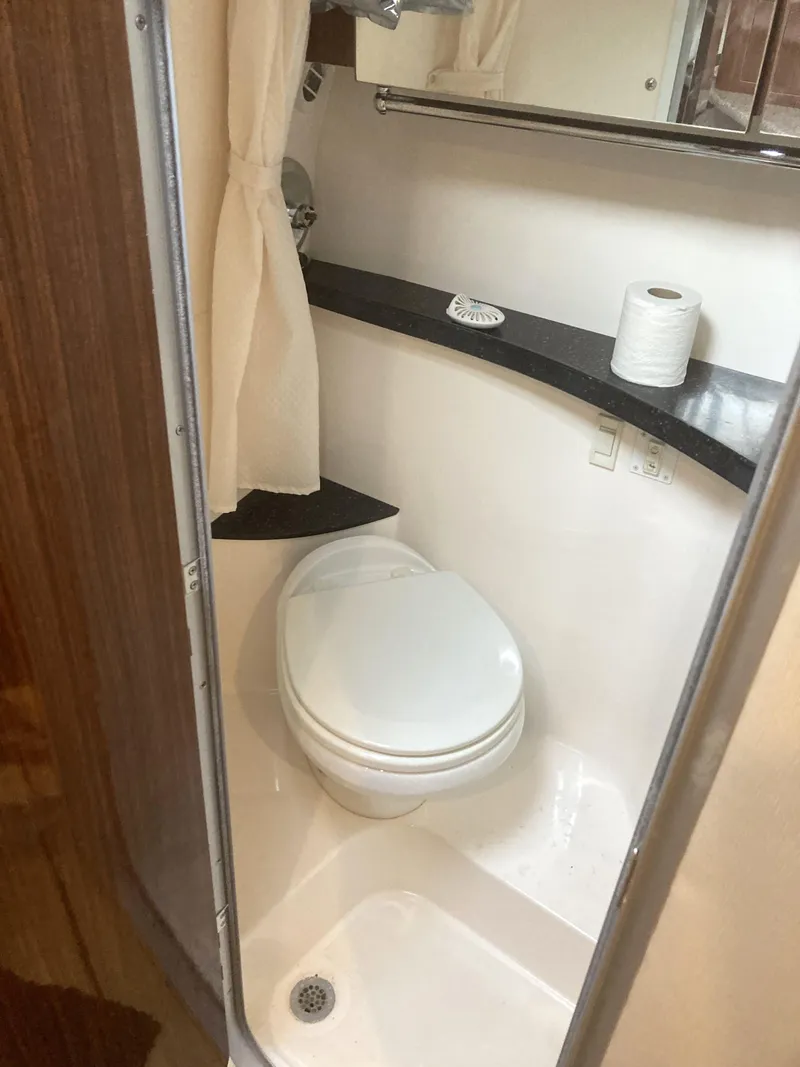 Slide: The Image of Compact bathroom in 2015 Regal 28 Express boat with toilet and shower. - 9