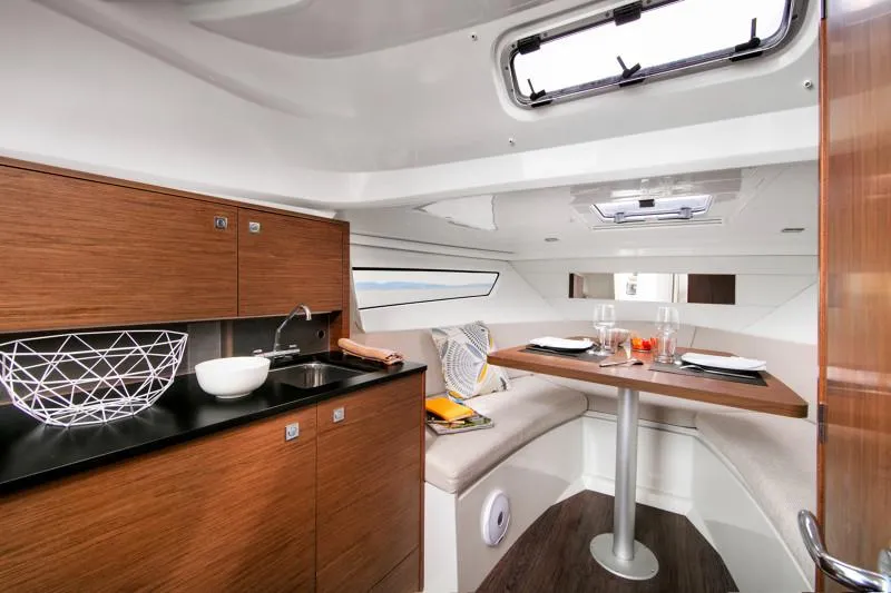 Slide: The Image of Luxurious interior of 2025 Jeanneau Leader 9.0 WA S2 boat with modern kitchen and dining area. - 10