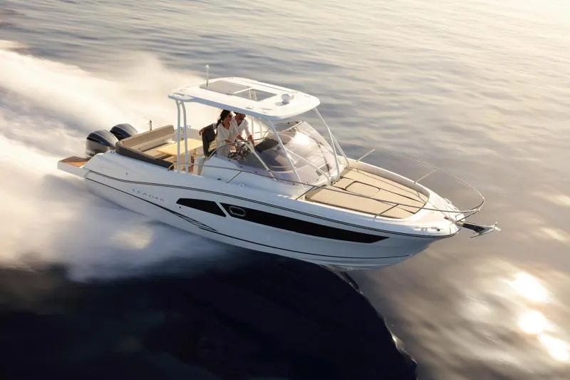 Slide: The Image of 2025 Jeanneau Leader 9.0 WA S2 cruising on open water at sunset. - 2