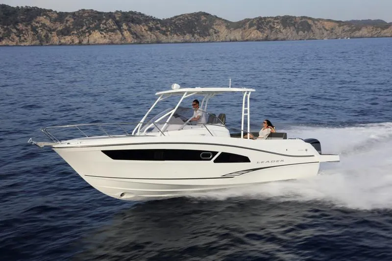 Slide: The Image of 2025 Jeanneau Leader 9.0 WA S2 cruising on open water, scenic coastline in background. - 4
