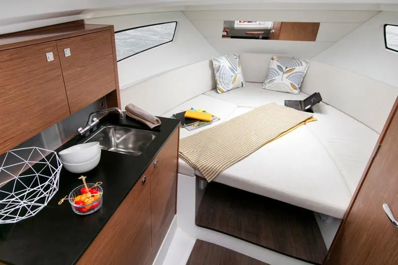 Slide: The Image of Luxurious interior of 2025 Jeanneau Leader 9.0 WA S2 with cozy cabin and kitchenette. - 9