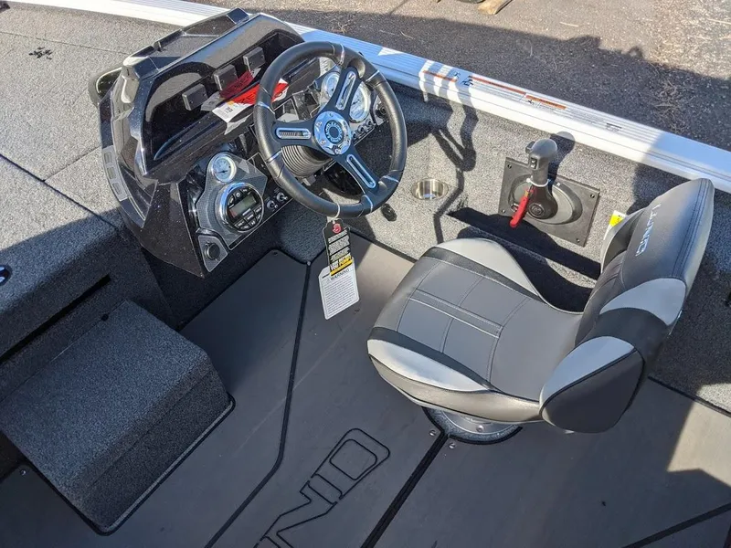 Slide: The Image of 2025 Lund 1875 Pro V Bass boat interior with steering wheel and captain's chair. - 8