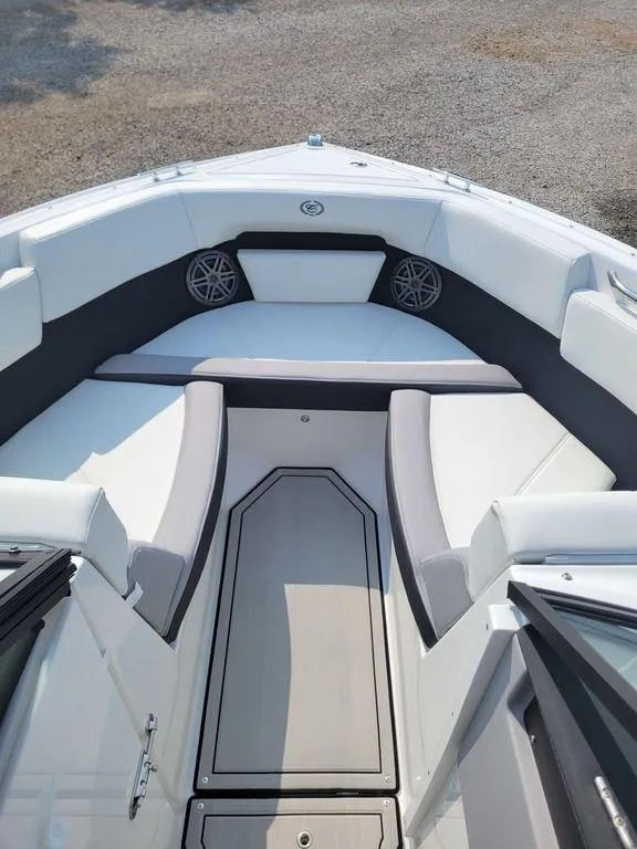 Slide: The Image of 2024 Cobalt CS22 boat interior with white and gray seating. - 10