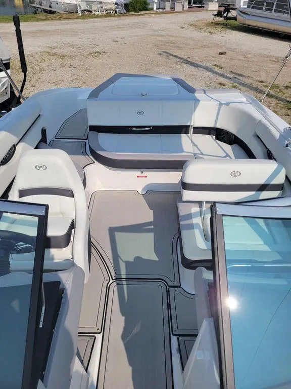 Slide: The Image of 2024 Cobalt CS22 boat interior with white and gray seating, open deck layout. - 11