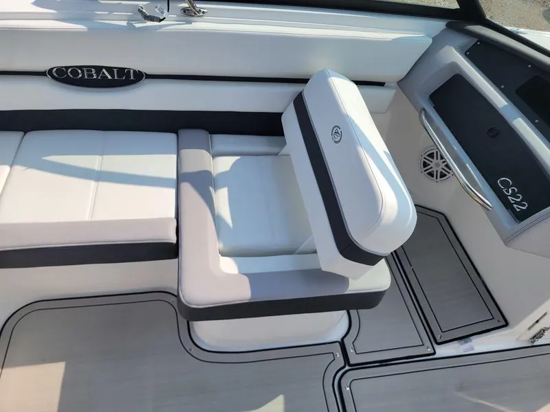 Slide: The Image of 2024 Cobalt CS22 boat interior with white and gray seating. - 14