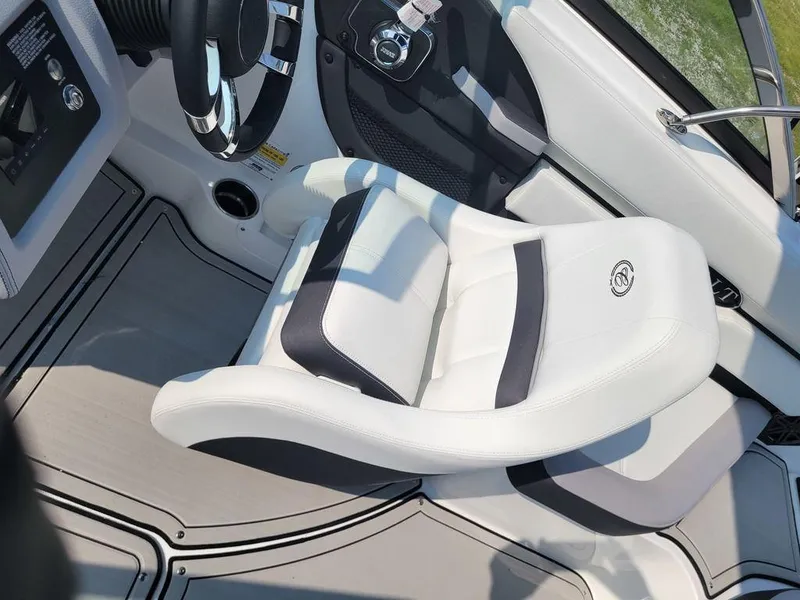 Slide: The Image of 2024 Cobalt CS22 boat interior with white and black captain's chair. - 5