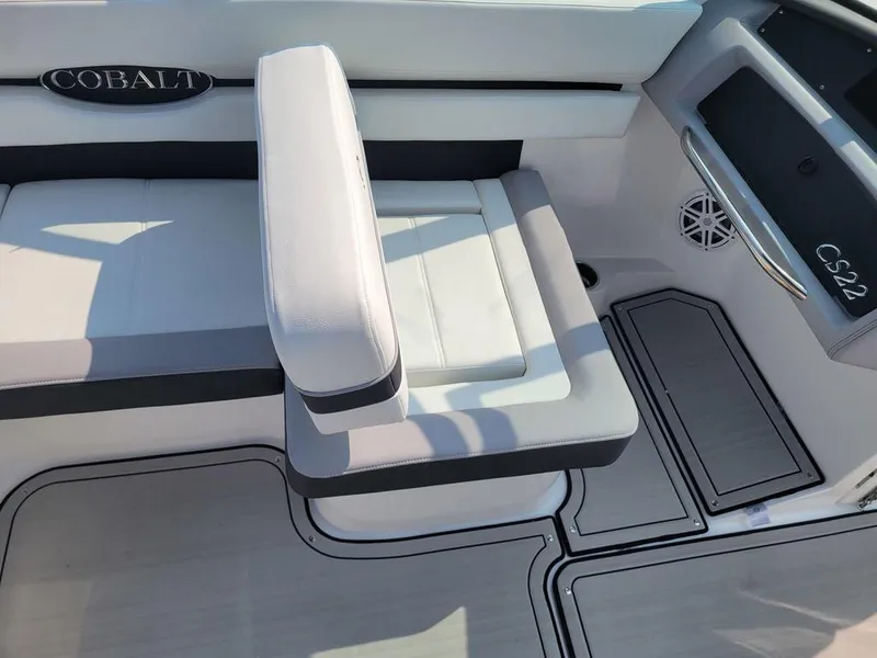 Slide: The Image of 2024 Cobalt CS22 boat interior with white and gray seating. - 6