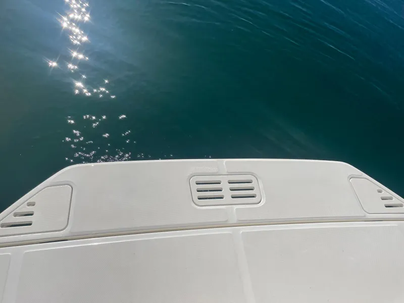 Slide: The Image of The swim platform of a boat extends over calm, blue water. - 35