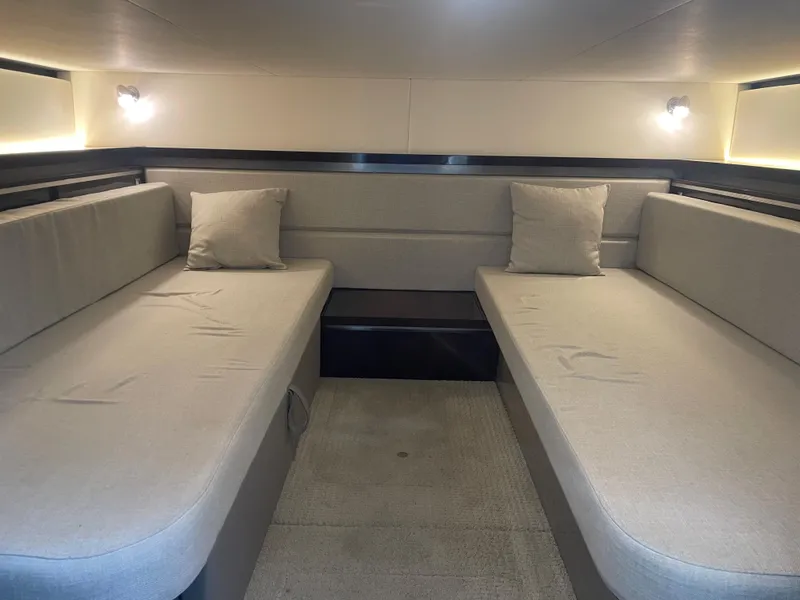 Slide: The Image of Interior of a 2020 Sea Ray Sundancer 320 with two cushioned benches and pillows. - 30