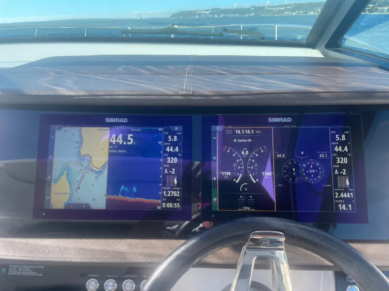 Slide: The Image of The image shows the dashboard of a 2020 Sea Ray Sundancer 320 with two Simrad displays. - 14