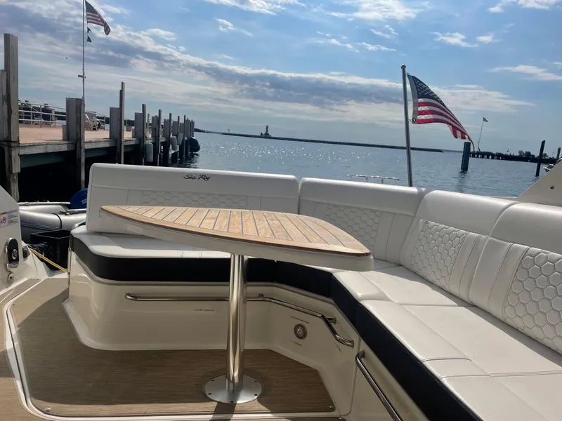 Slide: The Image of The image shows the stern of a Sea Ray Sundancer 320 with elegant seating and a table. - 17