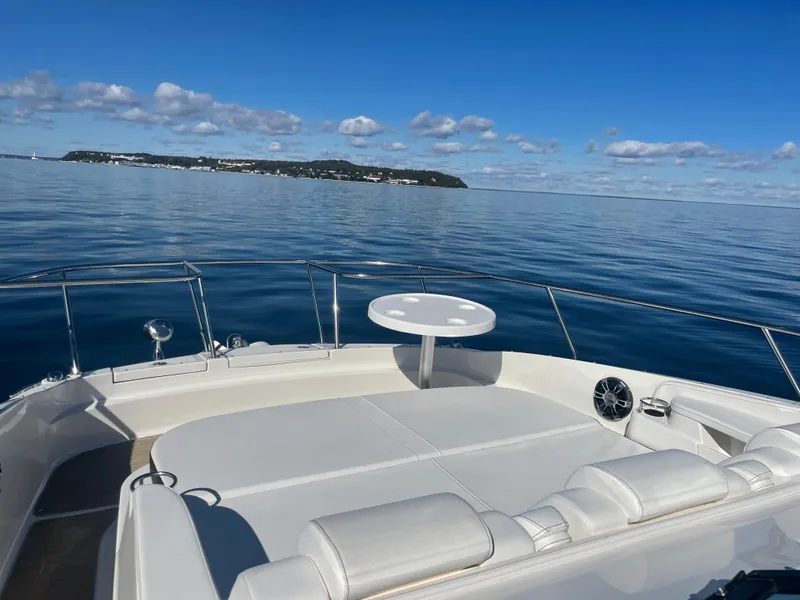 Slide: The Image of The image shows the deck of a 2020 Sea Ray Sundancer 320 on calm waters. - 9